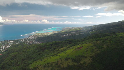 Aerial drone view showcasing the lush tropical vegetation covering the coastline of Tahiti island,...