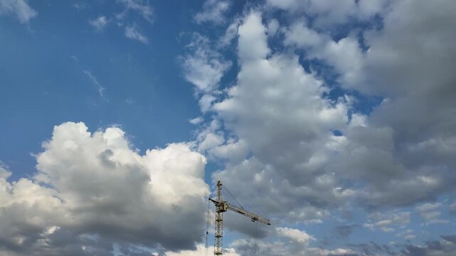 Timelapse of an industrial construction crane with cloudy background