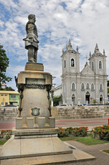 Fototapeta premium Cast iron statue at the monument to Marshal Floriano Peixoto, Brazil's second president, made by sculptor Lorenzo Petrucci. and the Bom Jesus dos Martírios Church, built in 1881. Maceio, Alagoas, 2022