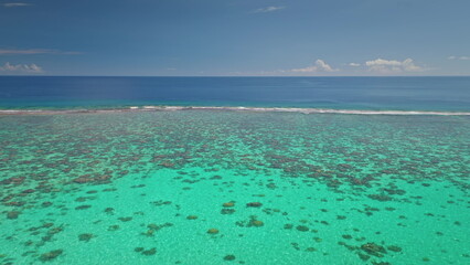 Stunning drone captures the vibrant coral reefs beneath the turquoise waters near Tahiti island,...
