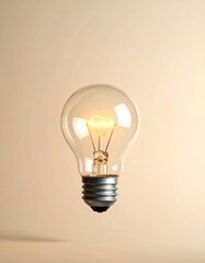 Illuminated lightbulb floats against a pale beige backdrop