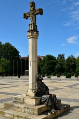Statue en bronze de José Maria Acuna représentant un pèlerin adossé à un calvaire sur la place San Marco de León