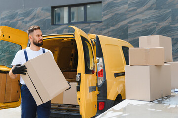 Delivery driver carrying package from yellow van
