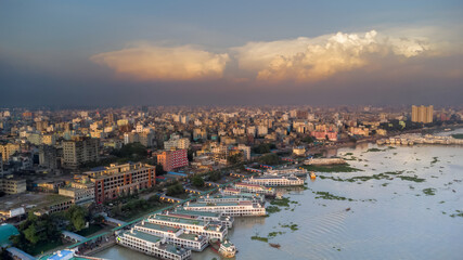A dramatic sky looms over the crowded city and its lively waterfront.