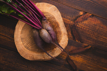 Bunch of fresh organic beets on rustic wooden background, raw beetroot autumn harvest top view copy...