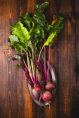 Bunch of fresh organic beets on rustic wooden background, raw beetroot autumn harvest top view...