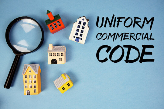 UCC Uniform Commercial Code text with house models and magnifying glass on blue background