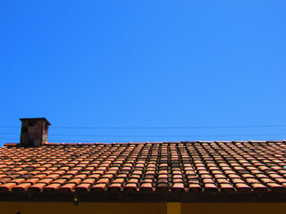 A roof of a house on a day with a radiant blue sky