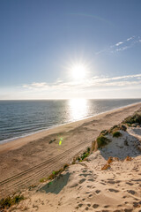 Scenic sunset over cliffs, pine forest, and golden beach in Mazagon, Huelva, Spain. Tranquil seascape ideal for travel, nature, and landscape concepts.