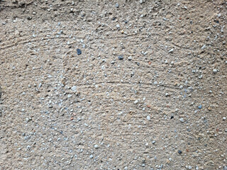 Texture of a gray concrete wall, gray background with small pebbles.