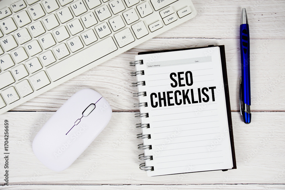 Aufkleber seo checklist text with keyboard and wireless mouse on wooden background