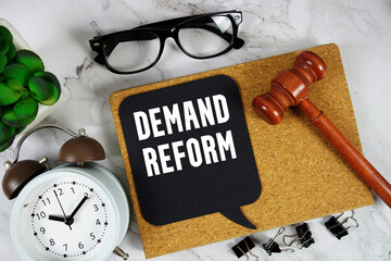 Demand Reform text on speech bubble with alarm clock and wooden gavel on marble background
