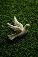 Paper bird peace logo over green grass, peace banner or background template