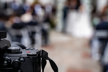 View of outdoor wedding ceremony with camera in focus.