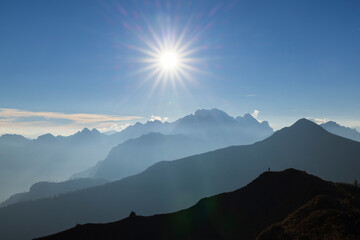 Bright sun shining over the Dolomites mountain range in Veneto, Italy
