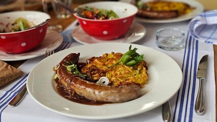 sausage with potatoes Rösti and vegetables