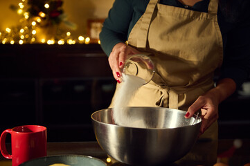 Woman Preparing Holiday Cookies with Christmas Lights in Cozy Kitchen Setting