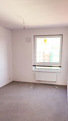 Bright room finished for sale without furniture against the background of construction and crane