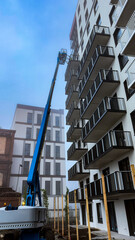 The tower works at a height on a construction site on a clear day