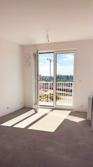 Bright room finished for sale without furniture against the background of construction and crane