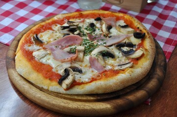 Mixed pizza with ham, cheese, mushroom, pepper and mushrooms 