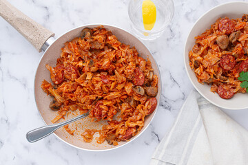 Bigos, Polish dish bigos, on the table, pan with stewed meat, with cabbage, chorizo sausages, mushrooms, homemade, without people,