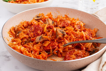 Bigos, Polish dish bigos, on the table, pan with stewed meat, with cabbage, chorizo sausages, mushrooms, homemade, without people,