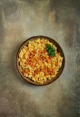risotto with shrimp, in a bowl, on a textured surface, with a side dish of fresh coriander, homemade, no people,