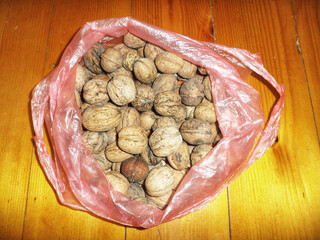 Bag of walnuts on a wooden table