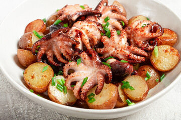 baby grilled octopus with golden baked potatoes and fresh herbs, Maltese cuisine, homemade, no people,