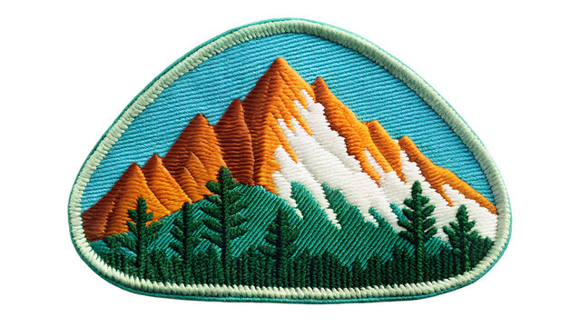 Embroidered mountain patch isolated on transparent background, showcasing a vibrant landscape with orange peaks, green trees, and a serene blue sky
