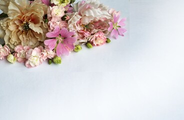 Bouquet of pink peonies and a notebook on a white background
