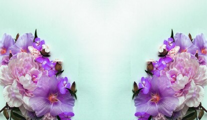 Flowers composition. Frame made of pink and purple hibiscus flowers on pastel green background. Flat lay, top view, copy space