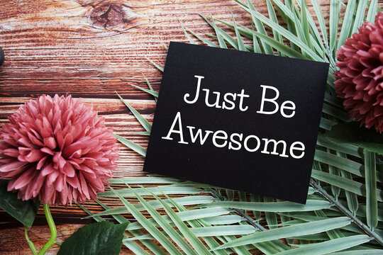 Naklejki Just Be Awesome text with flowers bouquet decoration on wooen background