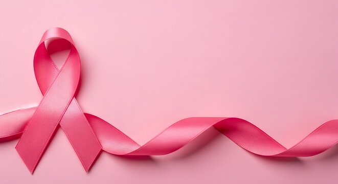 Elegant pink ribbon symbol of breast cancer awareness on a soft pink background