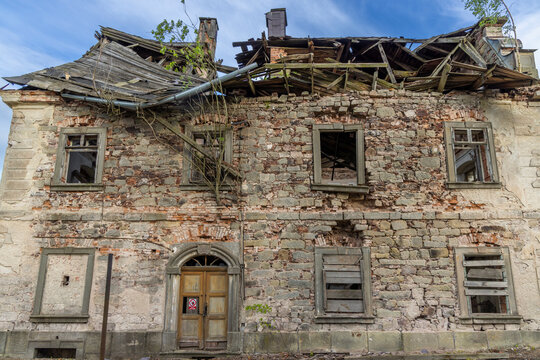 Ruined house with collapsed roof and broken windows in Sonov, Czechia