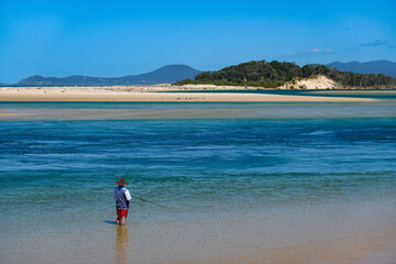 Man fishing in beautiful beach