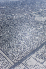 Snow-covered suburban landscape captured from above during winter