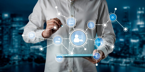 A business professional engages with a tablet, surrounded by a digital network. The image illustrates modern technology and communication in an urban setting. Tessel