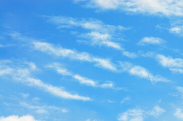 Cumulus clouds floating over clear blue sky on bright sunny day