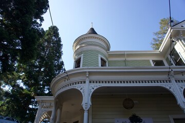 Victorian-style house with turret and ornate architectural details © lensbyMehlika
