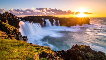 Dramatic coastal waterfall at sunrise