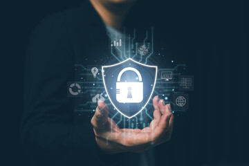 Cybersecurity concept with a businessman holding a shield lock icon, symbolizing data protection, network security, privacy, firewall, online safety, and digital information security technology.