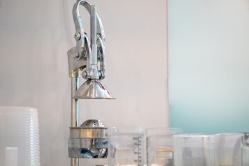 Metal Juicer on Counter with Clear Containers