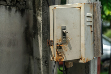 Rusty Electrical Box on Weathered Wall