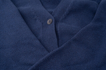 Navy blue merino wool sweater texture as background. Top view.
