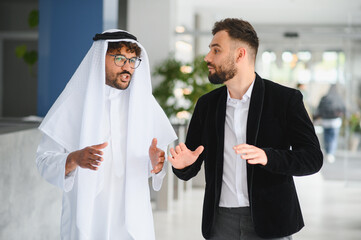 International business people meeting discussing in office hallway