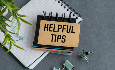 A notebook with a sign that says Helpful Tips on top of it