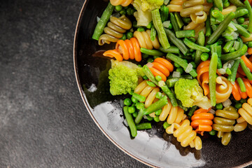 Trottole pasta vegetables green peas, green beans, kohlrabi cabbage, broccoli second course tasty snack fresh delicious gourmet food background on the table rustic food top view copy space