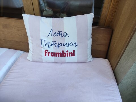 Moscow, Russia - September 21, 2025: A pillow with the inscription "Summer, Patricks, Frambini" as a decorative element on the outdoor veranda of a restaurant on Malaya Bronnaya Street 